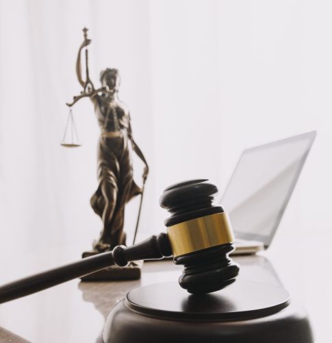 Business and lawyers discussing contract papers with brass scale on desk in office. Law, legal services, advice, justice and law concept picture with film grain effect